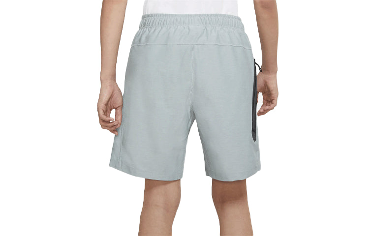 Image of شورت رياضي بشعار Nike Sportswear Tech Pack باللون الرمادي CZ9573-019